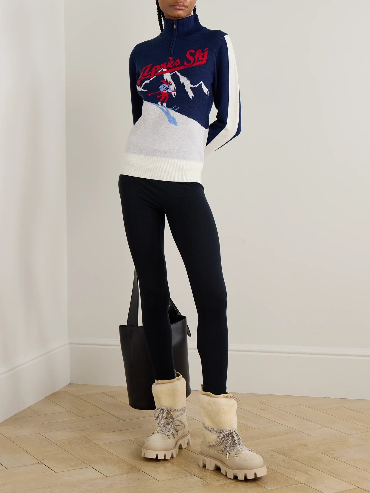Image of a model wearing Outerwear. Product name - Afterski Jacquard-knit Merino Wool Half-zip Sweater in Blue colour by brand - We Norwegians
