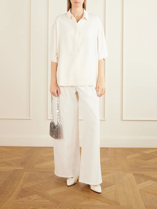 Image of a model wearing Tops. Product name - Eda Cady Polo Shirt in Ivory colour by brand - The Frankie Shop