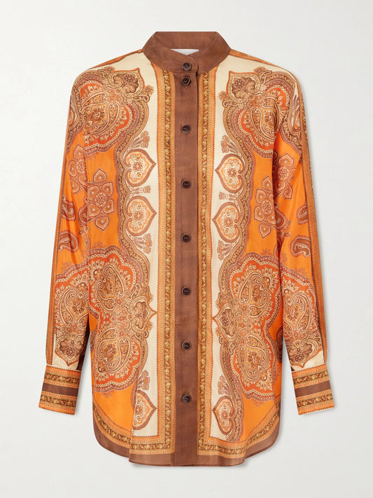 Image of a model wearing Tops. Product name - Mahon Dolman Printed Silk-satin Shirt in Orange colour by brand - Zimmermann