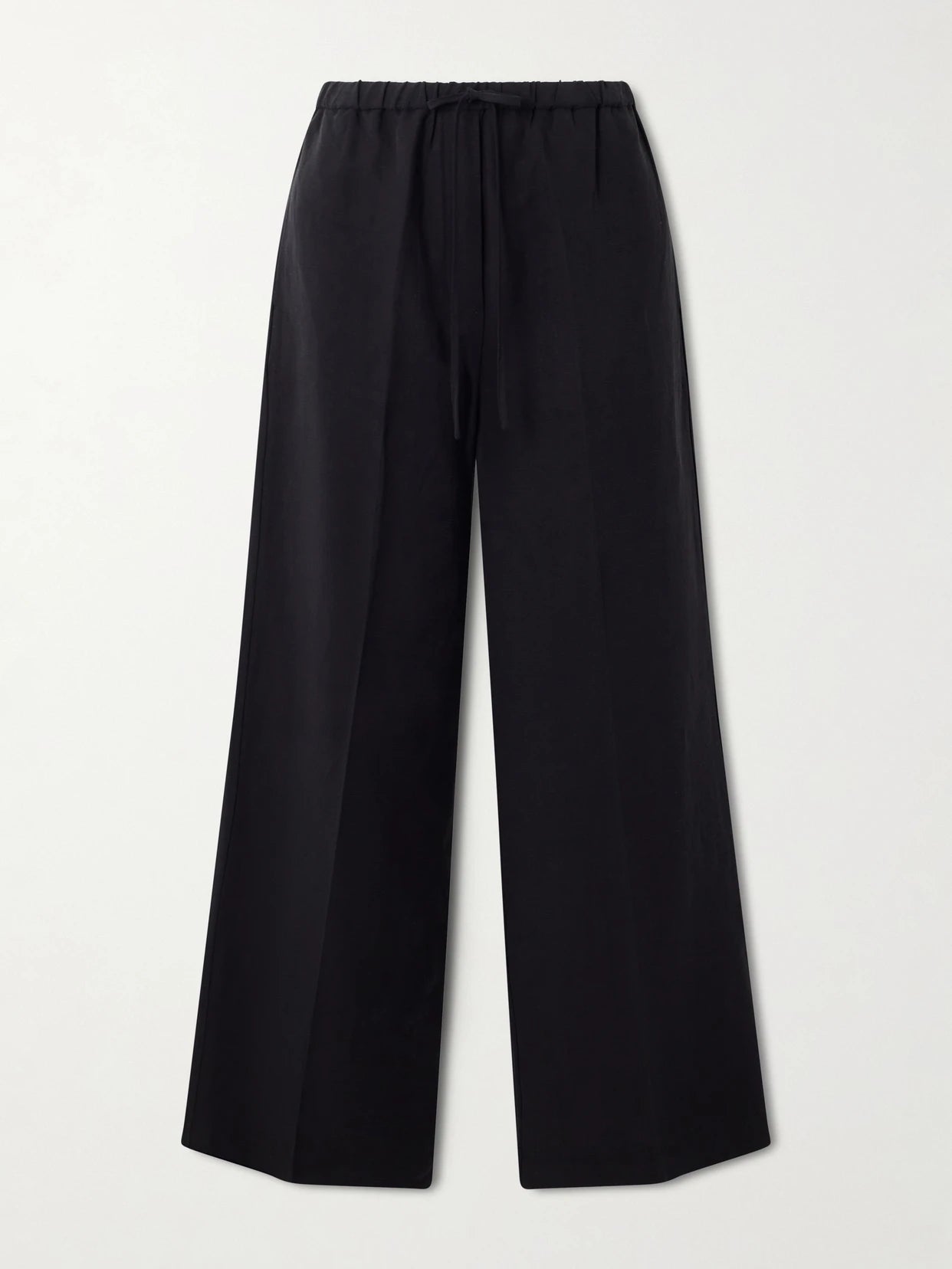 Image of a model wearing Pants. Product name - Linen Wide-leg Pants in Black colour by brand - TOTEME