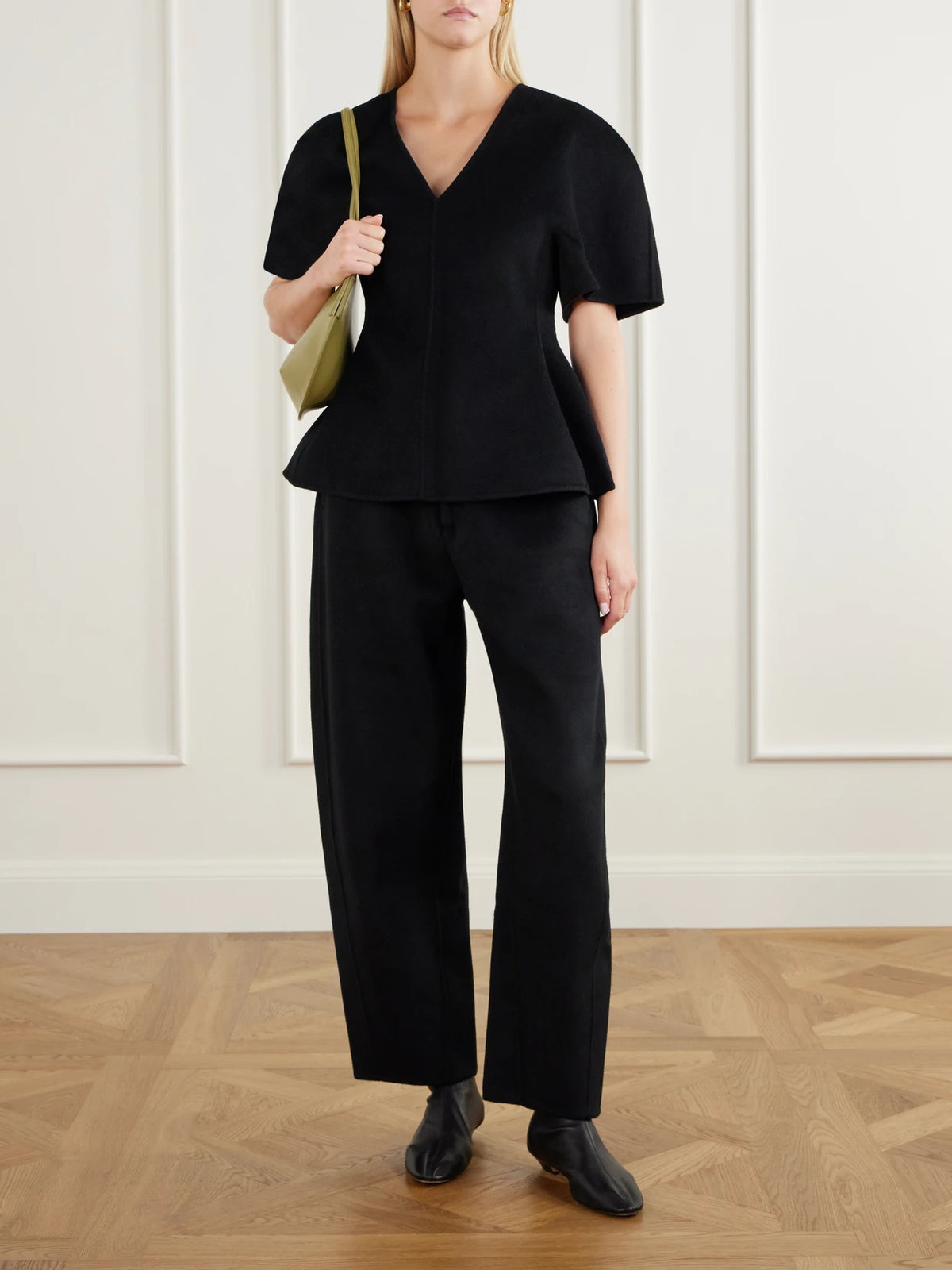 Image of a model wearing Tops. Product name - Wool And Cashmere-blend Blouse in Black colour by brand - LISA YANG