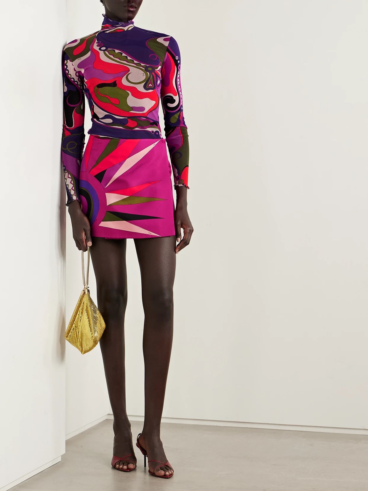 Image of a model wearing Skirts. Product name - Wrap-effect Printed Silk-twill Mini Skirt in Multi colour by brand - PUCCI