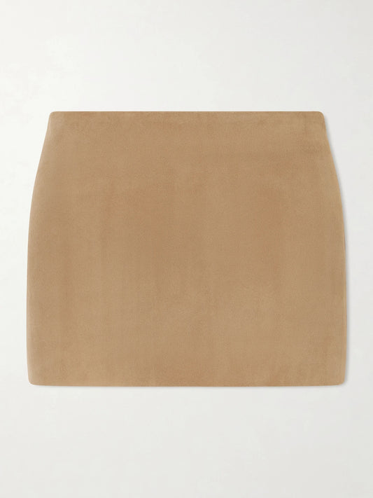 Image of a model wearing Skirts. Product name - Jett Suede Mini Skirt in Beige colour by brand - KHAITE