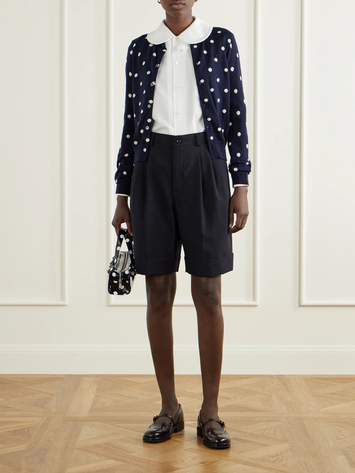 Image of a model wearing Outerwear. Product name - Polka-dot Wool Cardigan in Navy colour by brand - Comme des Garçons GIRL