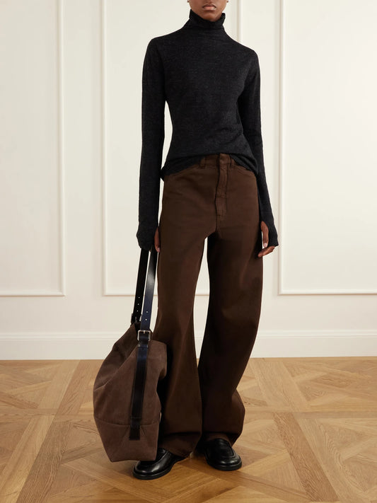 Image of a model wearing Outerwear. Product name - Merino Wool And Alpaca-blend Turtleneck Sweater in Black colour by brand - Lauren Manoogian