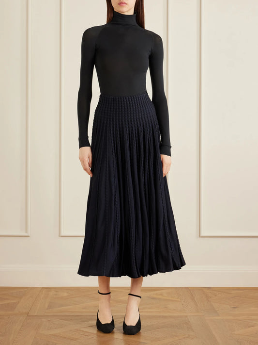 Image of a model wearing Skirts. Product name - Textured Knitted Midi Skirt in Navy colour by brand - Alaïa