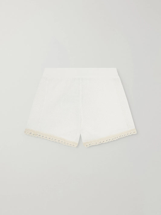 Image of a model wearing Shorts. Product name - Crochet-trimmed Cotton Shorts in White colour by brand - Stella McCartney