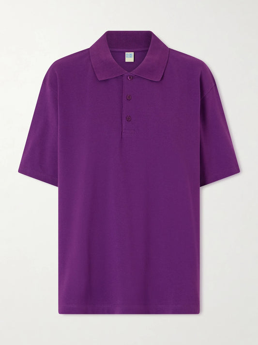 Image of a model wearing Tops. Product name - Julie Organic Cotton-piqué Polo Shirt in Purple colour by brand - FLORE FLORE