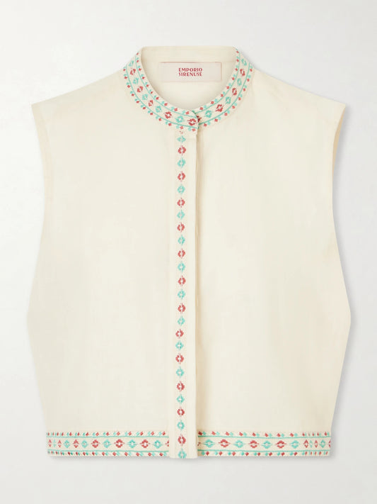 Image of a model wearing Tops. Product name - Andorra Astragal Mare Embroidered Linen And Cotton-blend Top in Cream colour by brand - Emporio Sirenuse