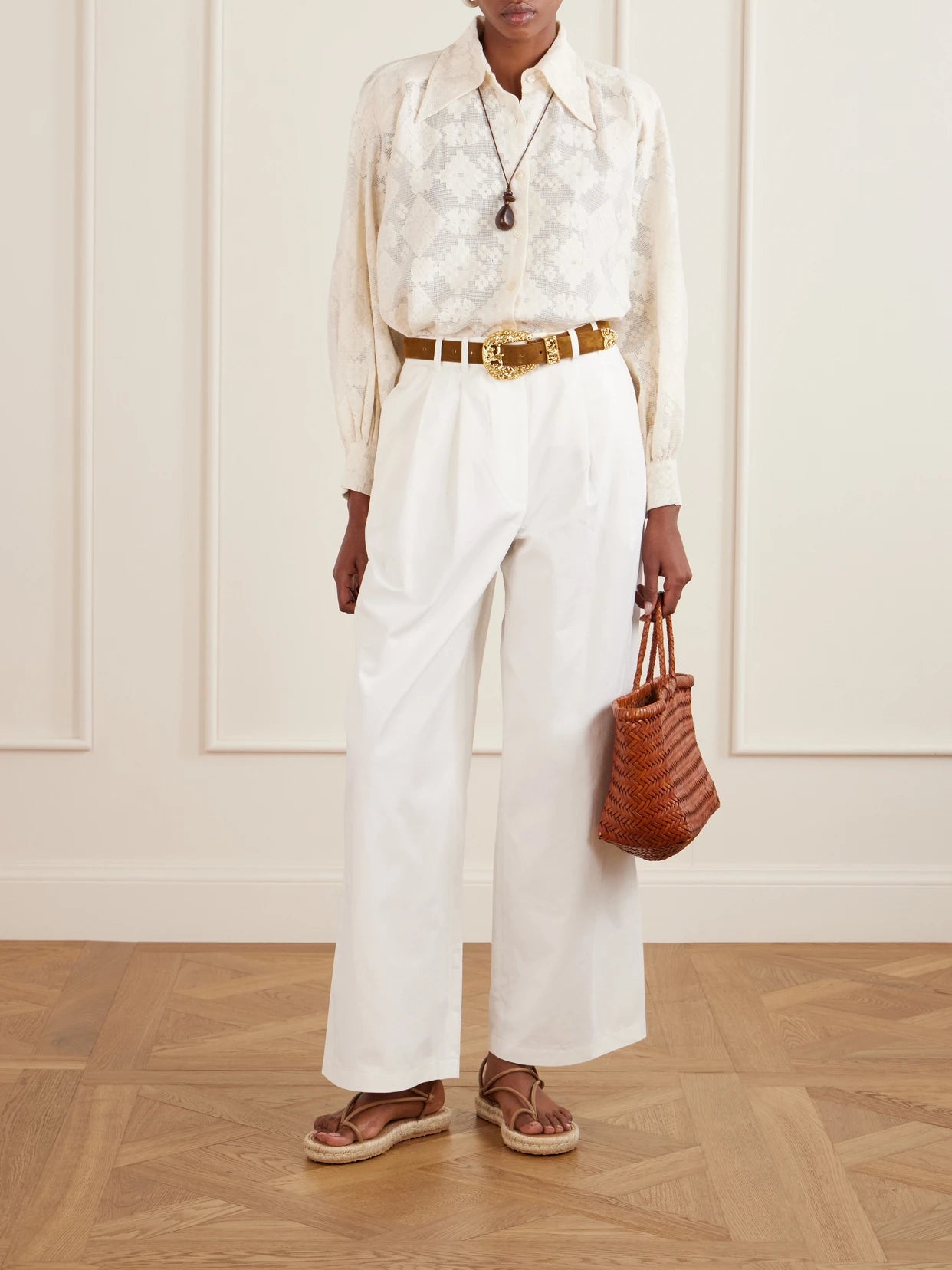 Image of a model wearing Pants. Product name - Lisa Pleated Cotton-twill Wide-leg Pants in White colour by brand - DÔEN