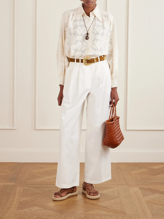 Image of a model wearing Pants. Product name - Lisa Pleated Cotton-twill Wide-leg Pants in White colour by brand - DÔEN