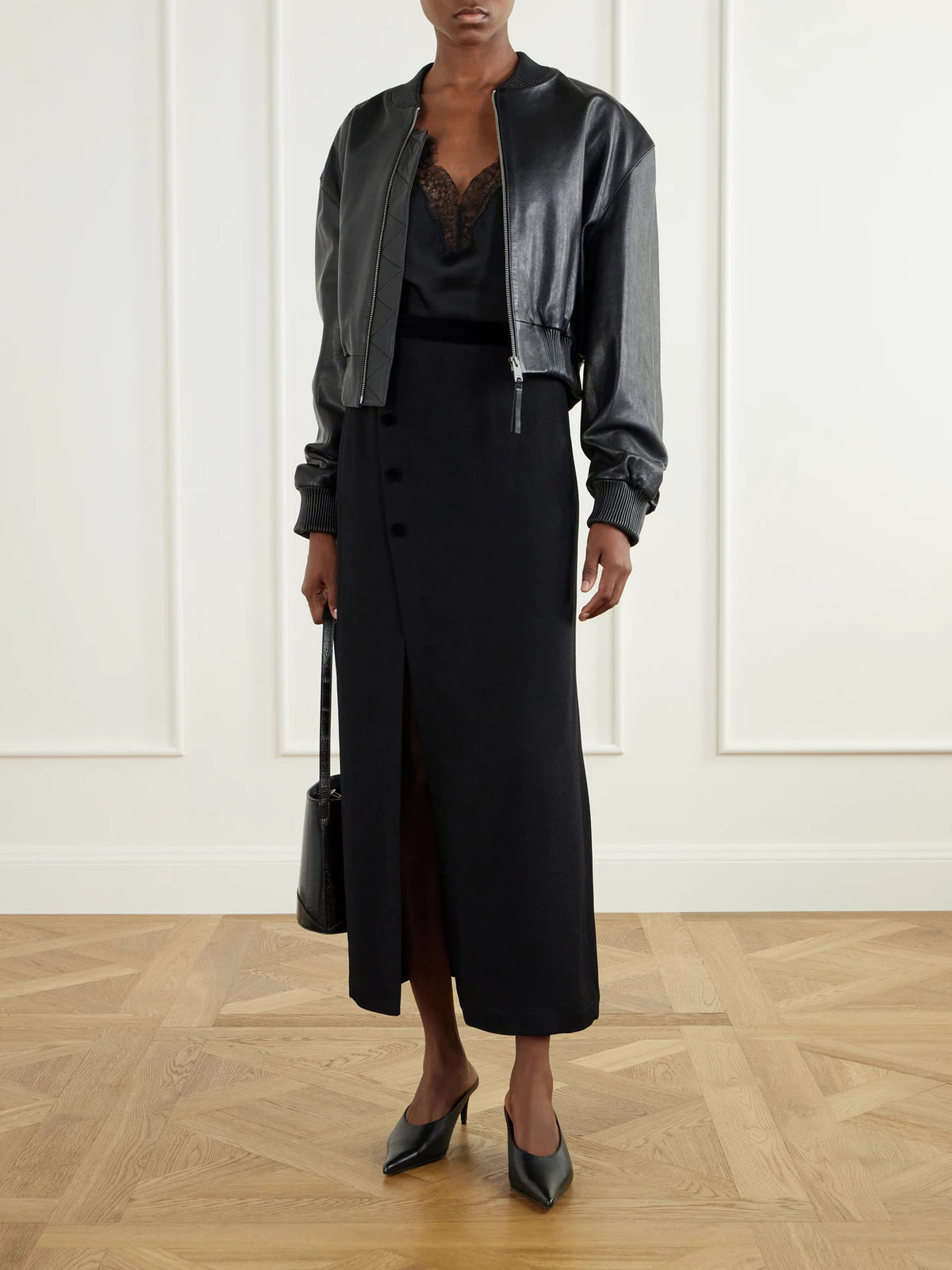 Image of a model wearing Skirts. Product name - Ara Velvet-trimmed Crepe Midi Skirt in Black colour by brand - BLAZÉ Milano