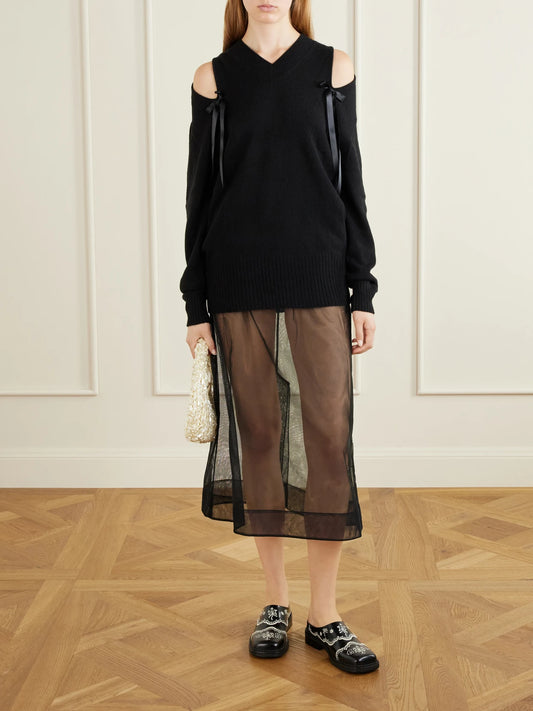 Image of a model wearing Outerwear. Product name - Bow-detailed Cashmere Sweater in Black colour by brand - Simone Rocha
