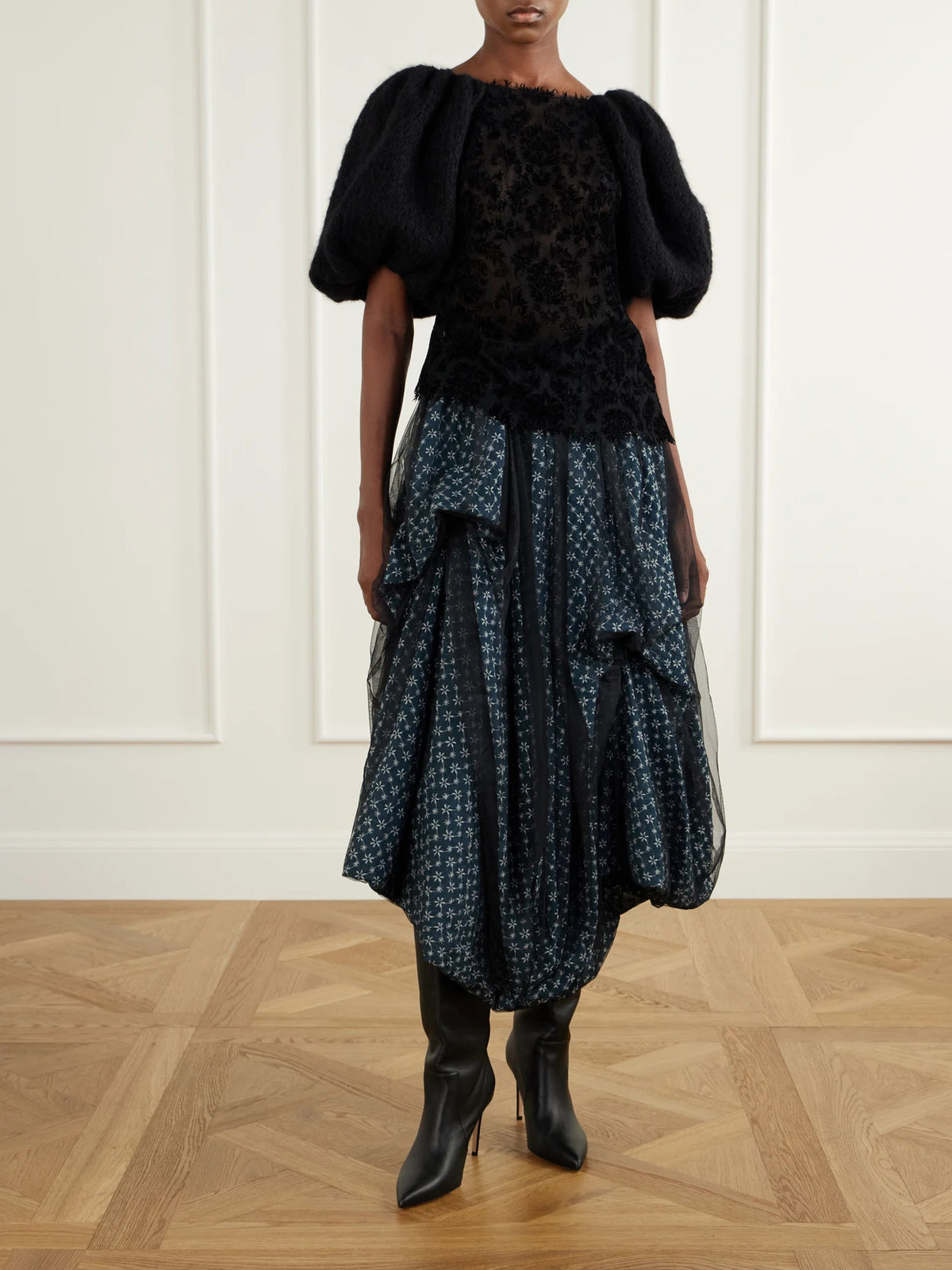 Image of a model wearing Tops. Product name - Laia Lace-trimmed Knitted Blouse in Black colour by brand - Pauline Dujancourt