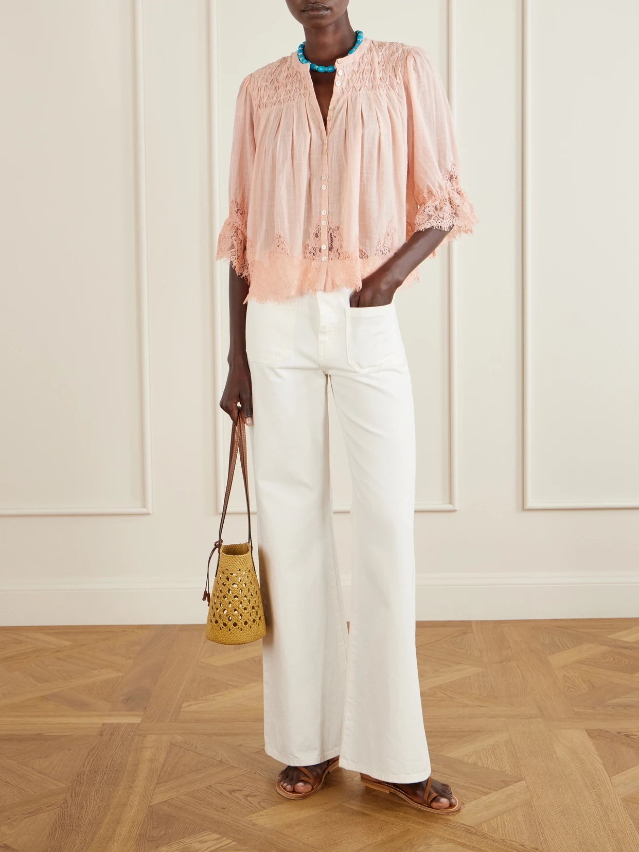 Image of a model wearing Tops. Product name - Erika Shirred Lace-trimmed Cotton-voile Blouse in Peach colour by brand - RIXO