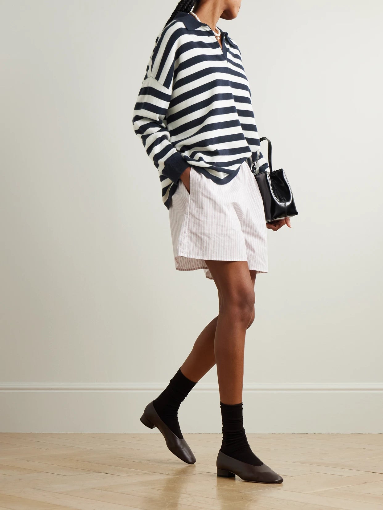 Image of a model wearing Outerwear. Product name - Victoria Oversized Striped Cashmere Polo Sweater in Navy colour by brand - Arch4
