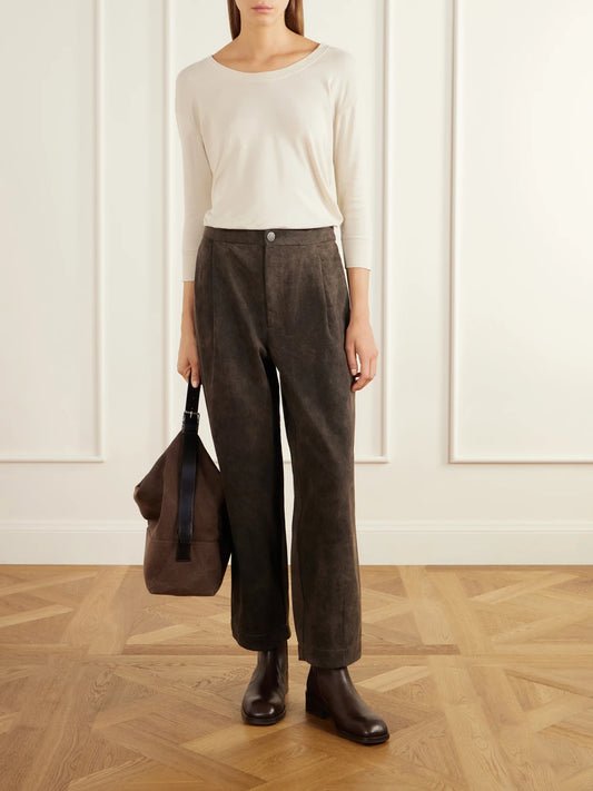 Image of a model wearing Pants. Product name - Pleated Cotton-twill Tapered Pants in Green colour by brand - Lauren Manoogian