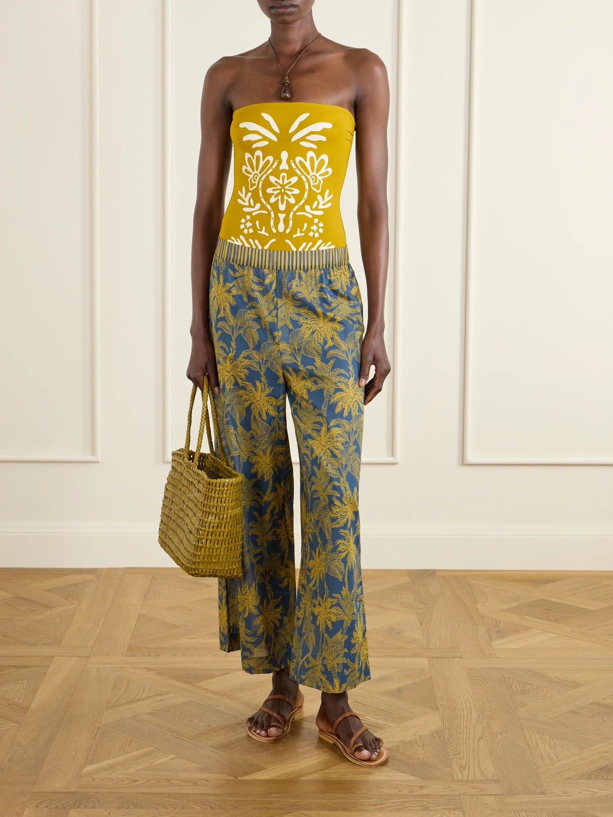 Image of a model wearing Pants. Product name - Itinerant Printed Cotton-voile Straight-leg Pants in Navy colour by brand - Eres