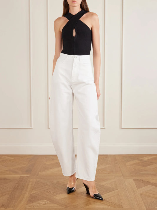 Image of a model wearing Tops. Product name - Cross Body Compact Bodysuit in Black colour by brand - Alaïa