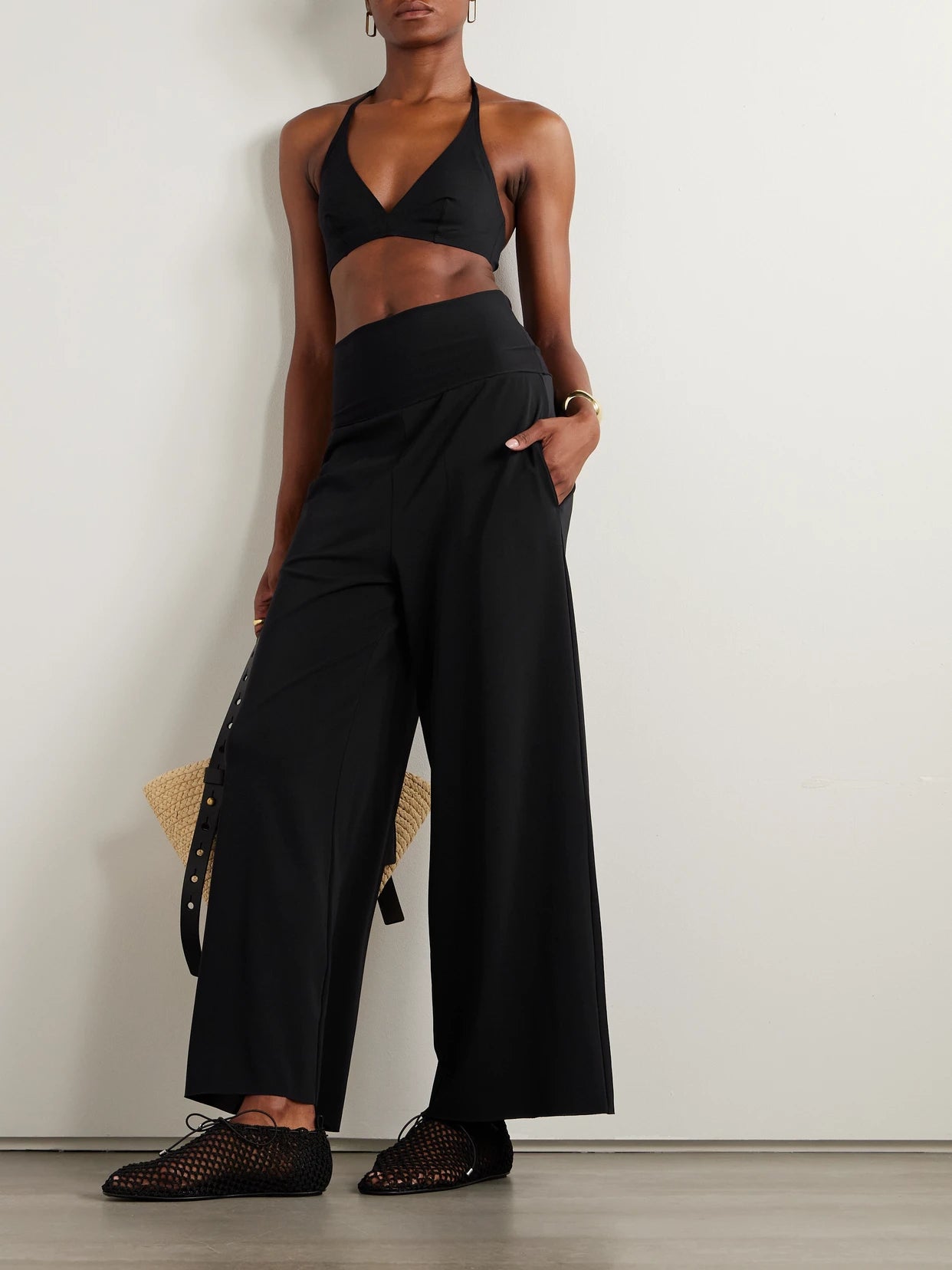 Image of a model wearing Pants. Product name - Les Essentiels Dao Convertible Wide-leg Pants in Black colour by brand - Eres
