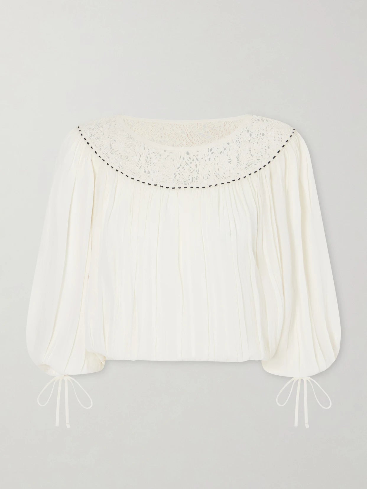 Image of a model wearing Tops. Product name - Nelida Lace-trimmed Silk-gauze Blouse in Ecru colour by brand - ISABEL MARANT