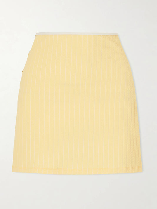 Image of a model wearing Skirts. Product name - Poolside Cut-out Jacquard Coverup in Yellow colour by brand - Eres