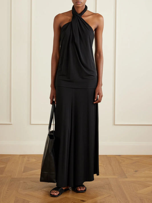 Image of a model wearing Tops. Product name - Jersey Halterneck Blouse in Black colour by brand - TOTEME