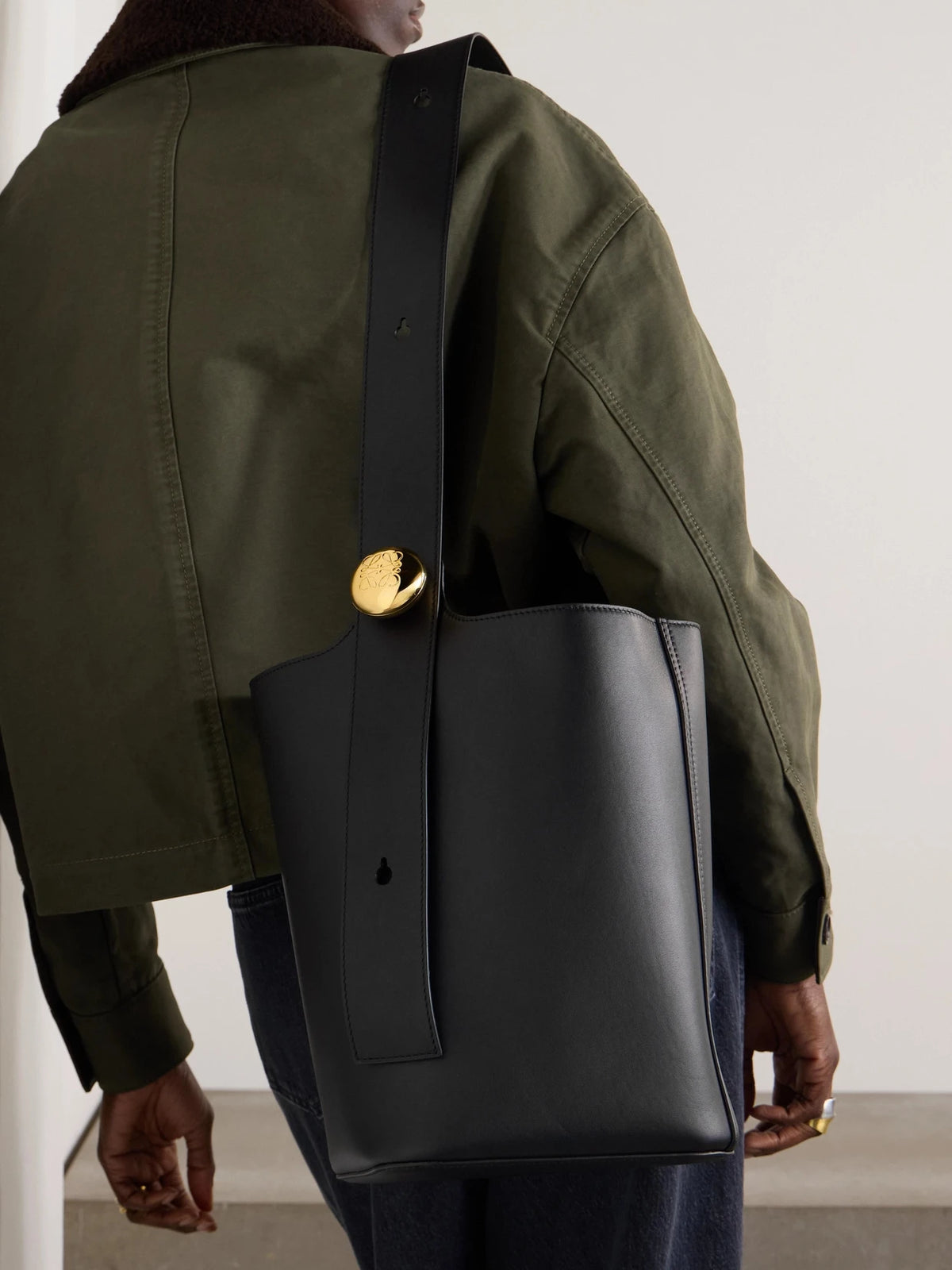 Image of Bags. Product name - Pebble Embellished Leather Bucket Bag in Black colour by brand - LOEWE