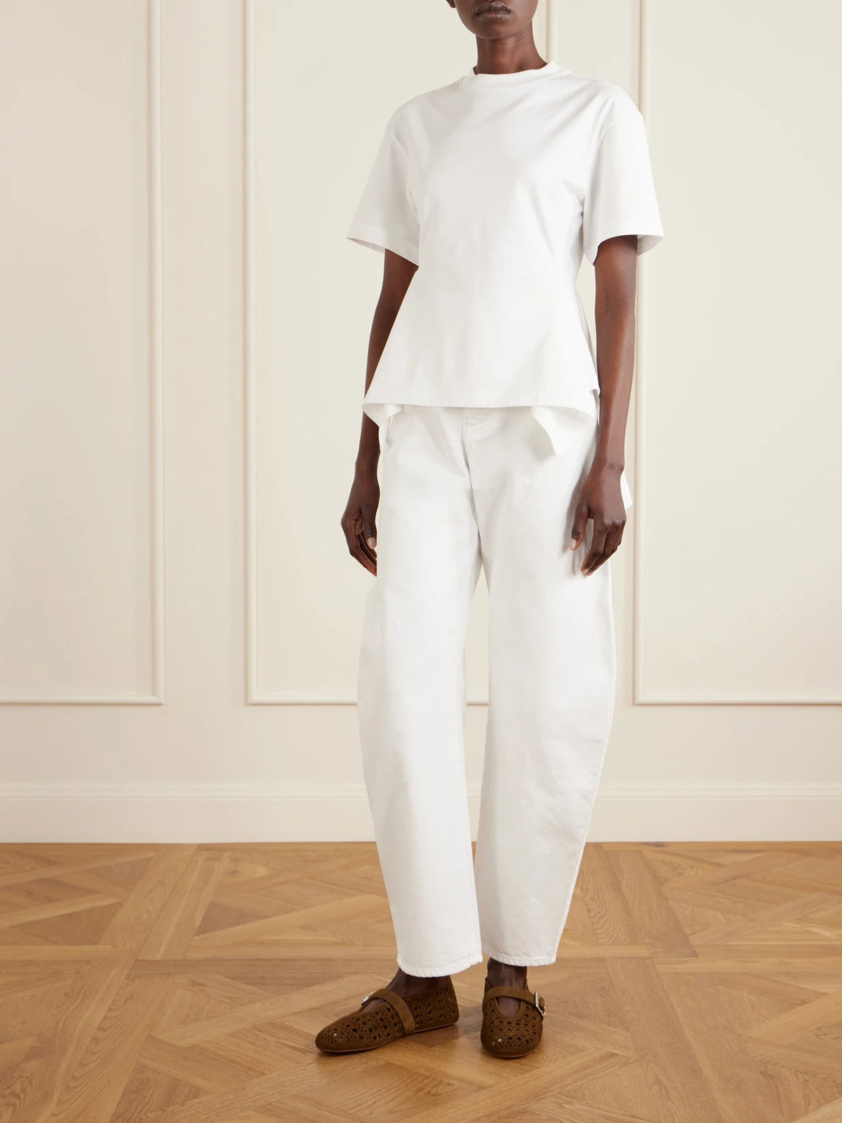 Image of a model wearing Tops. Product name - Pleated Cotton-jersey T-shirt in White colour by brand - Alaïa