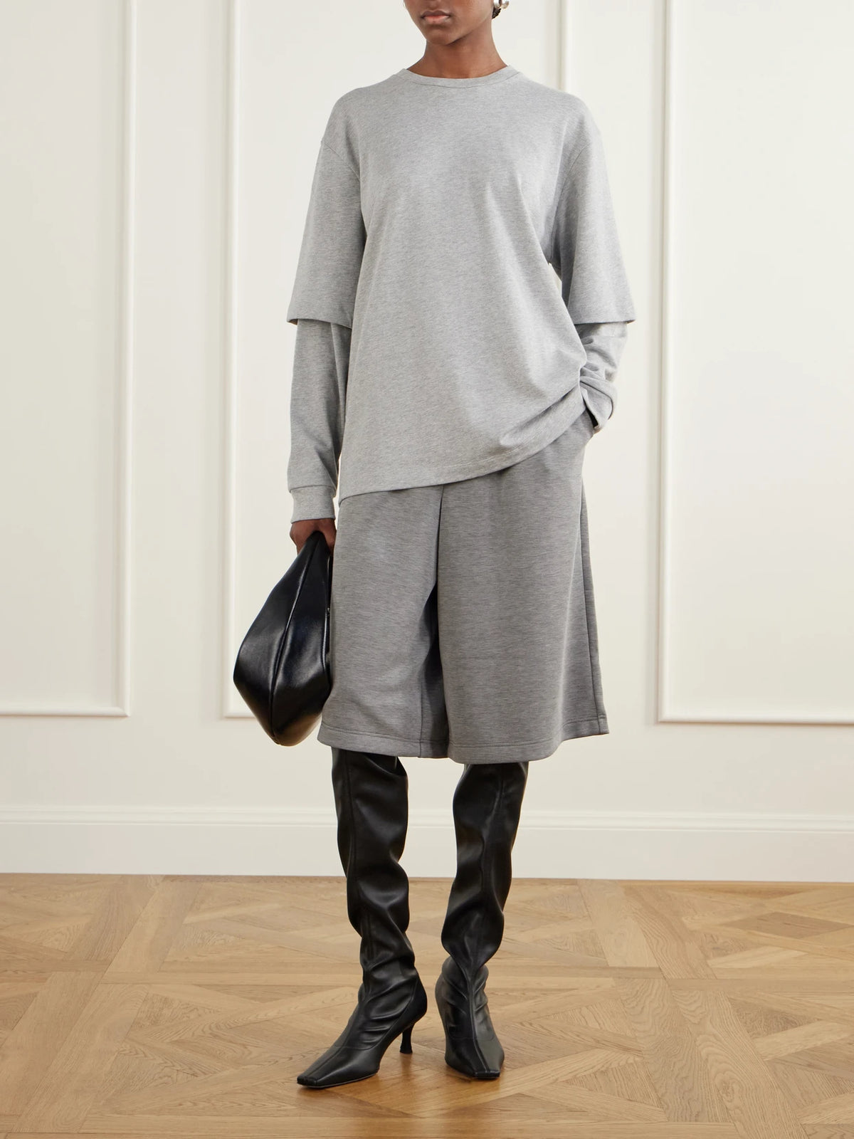 Image of a model wearing Shorts. Product name - Feather Weight Jersey Shorts in Gray colour by brand - Tibi