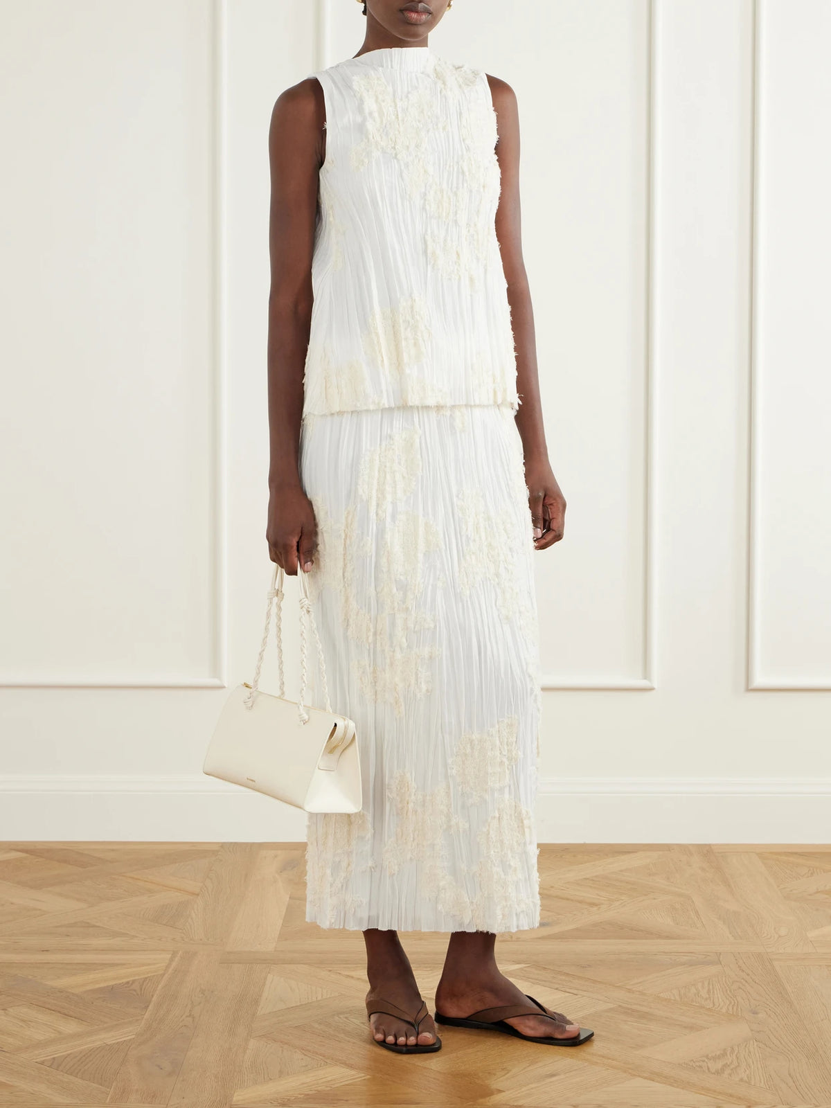 Image of a model wearing Skirts. Product name - Esse Embellished Pleated Voile Cotton And Silk-blend Midi Skirt in Ivory colour by brand - KALLMEYER