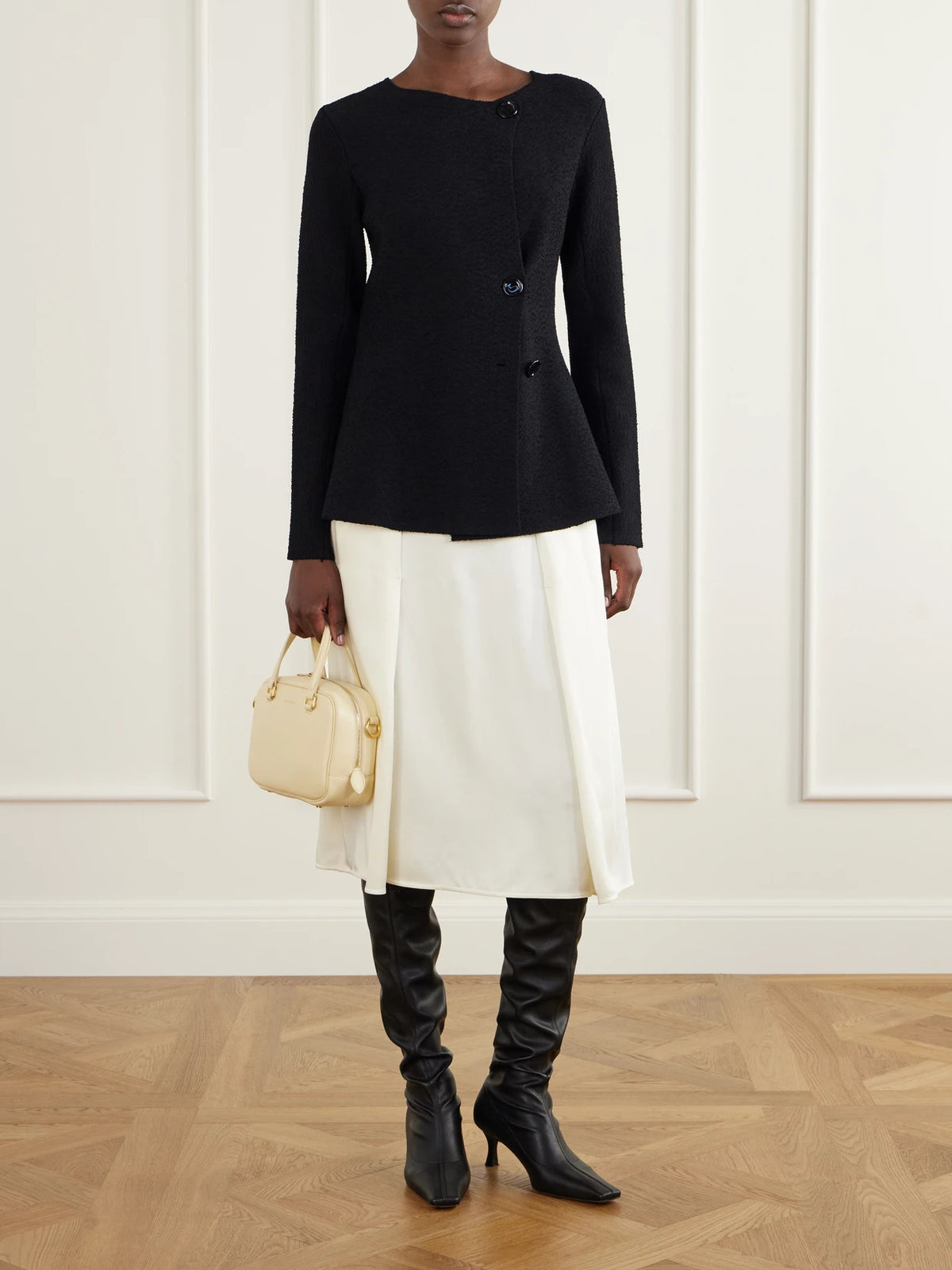 Image of a model wearing Skirts. Product name - Pleated Satin Midi Skirt in Off-white colour by brand - Jil Sander