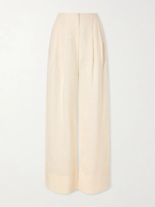 Image of a model wearing Pants. Product name - Ancestra Pleated Linen Wide-leg Pants in Ivory colour by brand - Andres Otalora