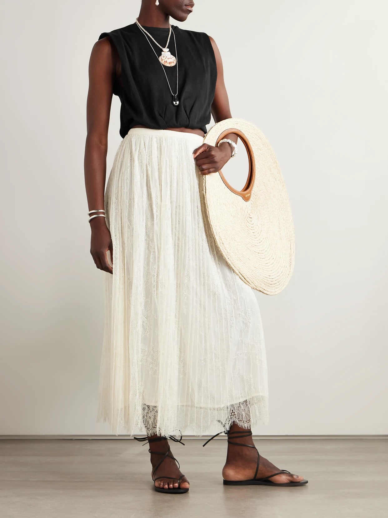 Image of a model wearing Tops. Product name - Muraya Cropped Jersey T-shirt in Black colour by brand - Johanna Ortiz