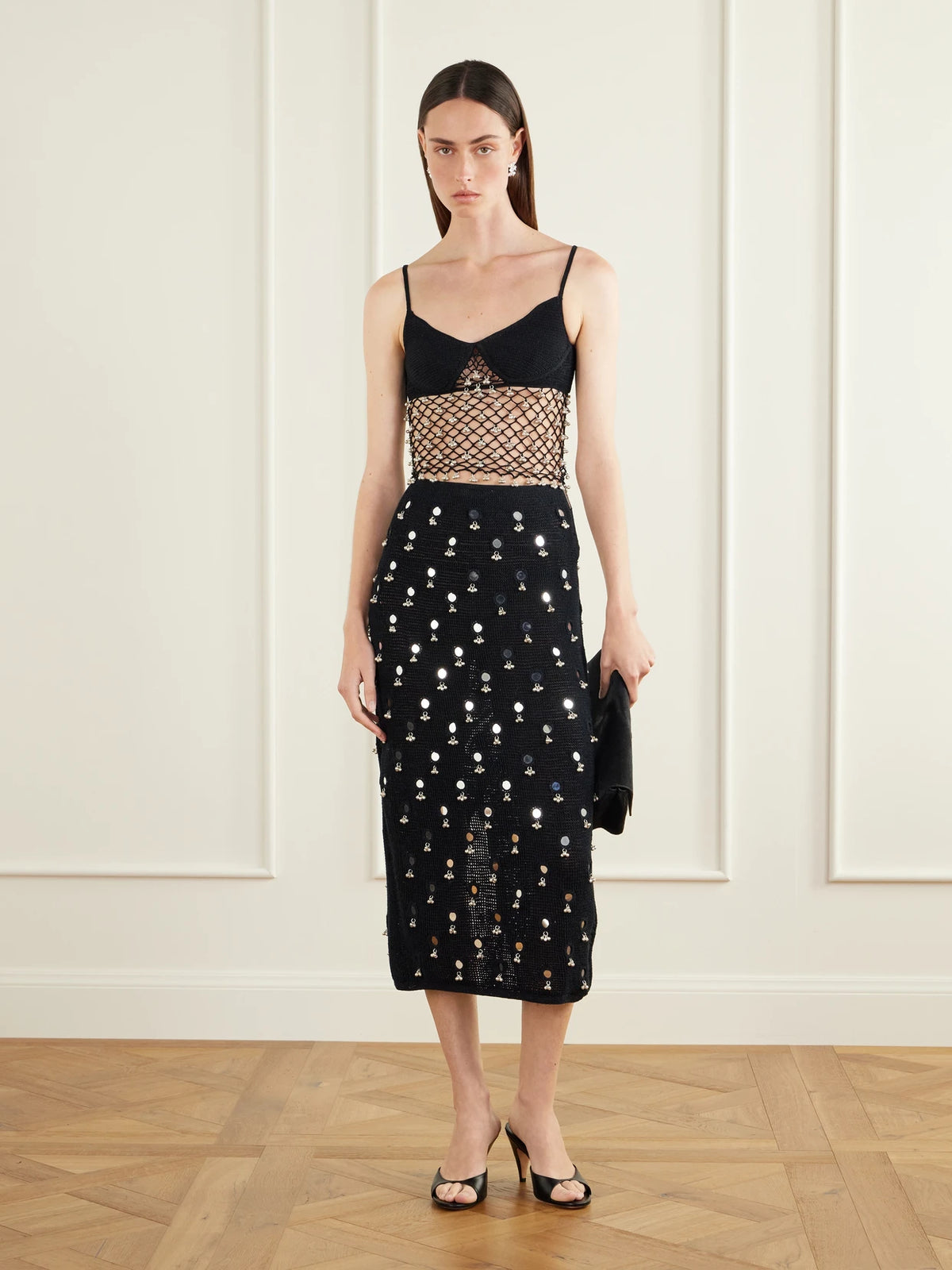 Image of a model wearing Skirts. Product name - Anastacia Embellished Cotton Crochet-knit Midi Skirt in Black colour by brand - Yoshita 1967