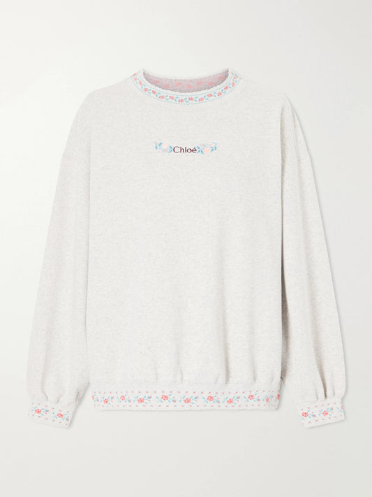 Image of a model wearing Tops. Product name - Logo-embroidered Scalloped Cotton-jersey Sweatshirt in Gray colour by brand - Chloé