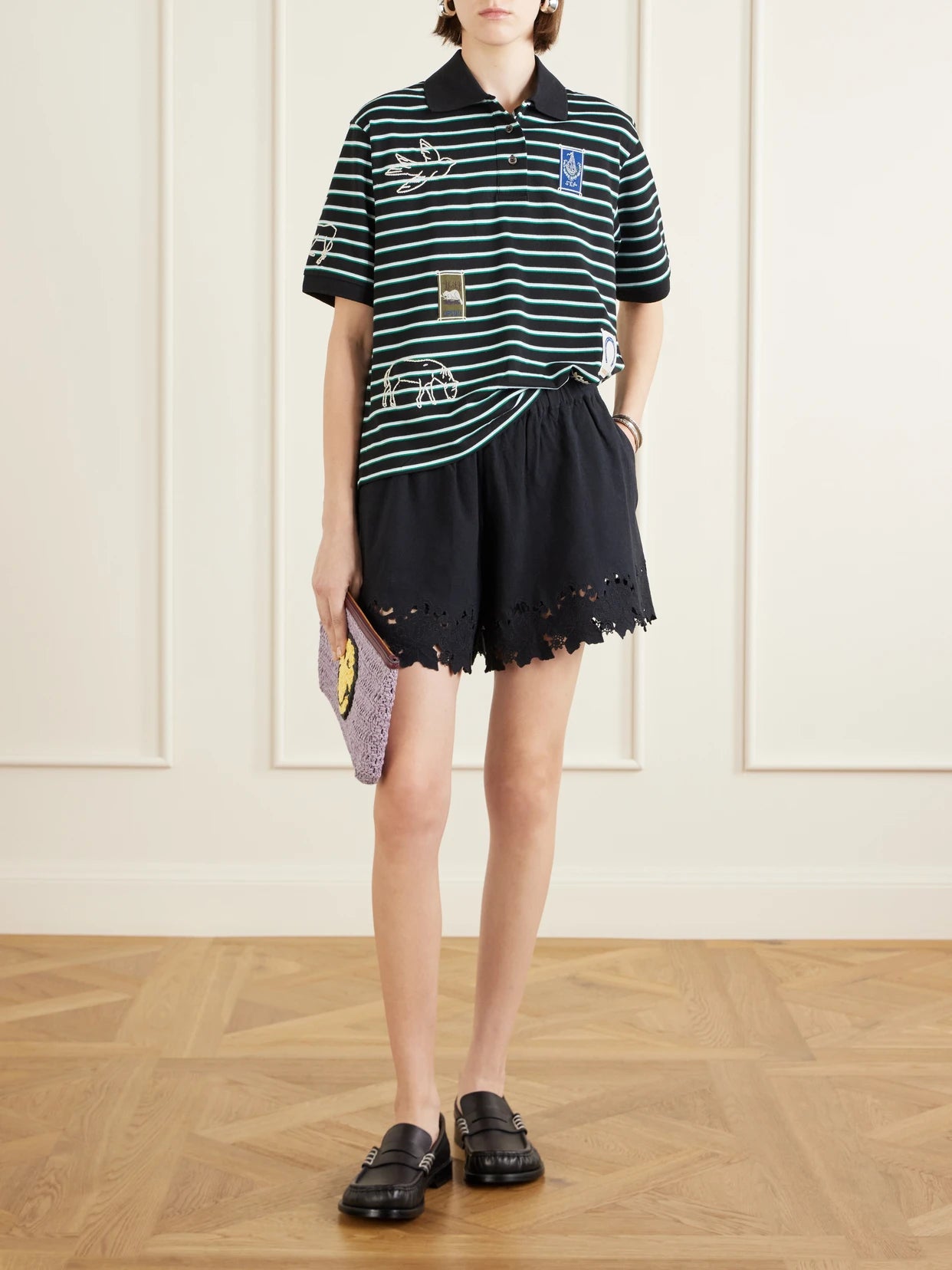 Image of a model wearing Tops. Product name - Winslow Appliquéd Embroidered Striped Cotton Polo Shirt in Black colour by brand - Sea