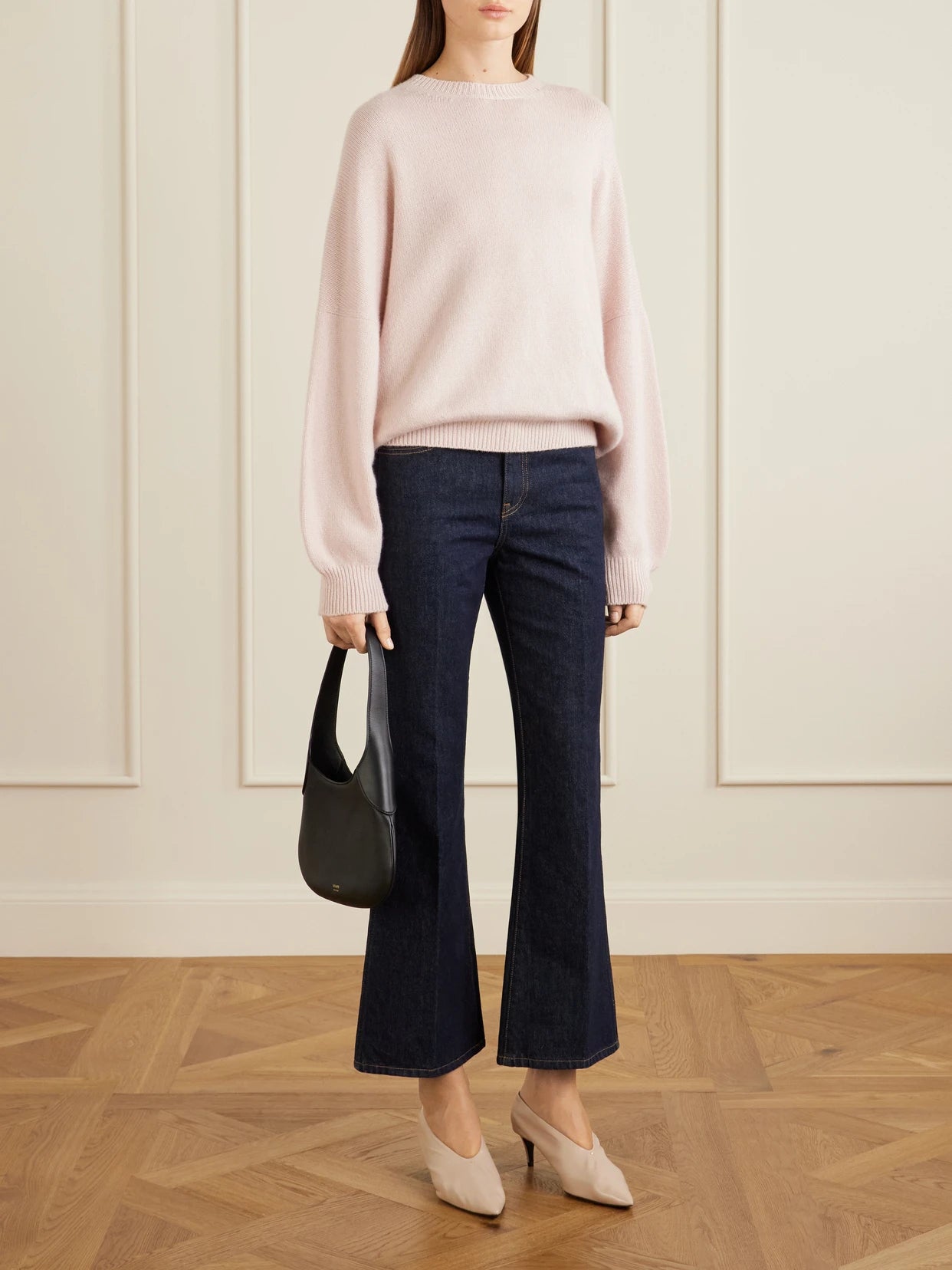Image of a model wearing Outerwear. Product name - Margaux Cashmere Sweater in Pastel pink colour by brand - KHAITE