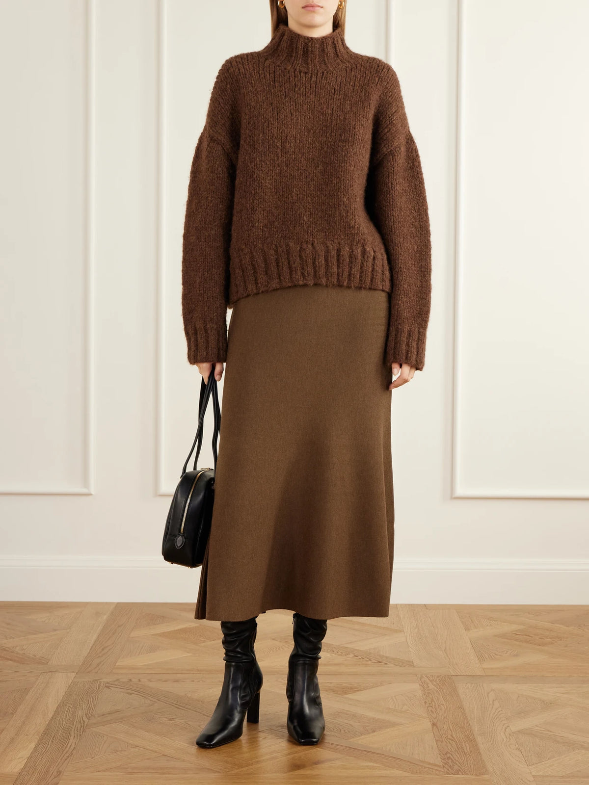 Image of a model wearing Skirts. Product name - Wool Midi Skirt in Brown colour by brand - SIMKHAI