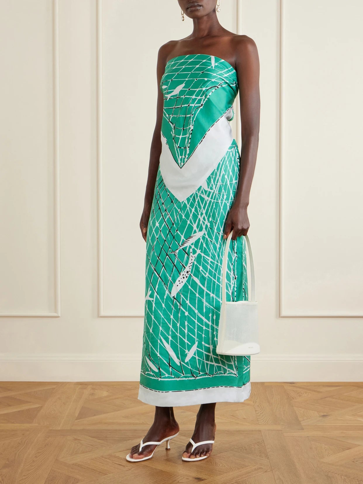 Image of a model wearing Skirts. Product name - Linnie Printed Silk Maxi Skirt in Green colour by brand - Altuzarra