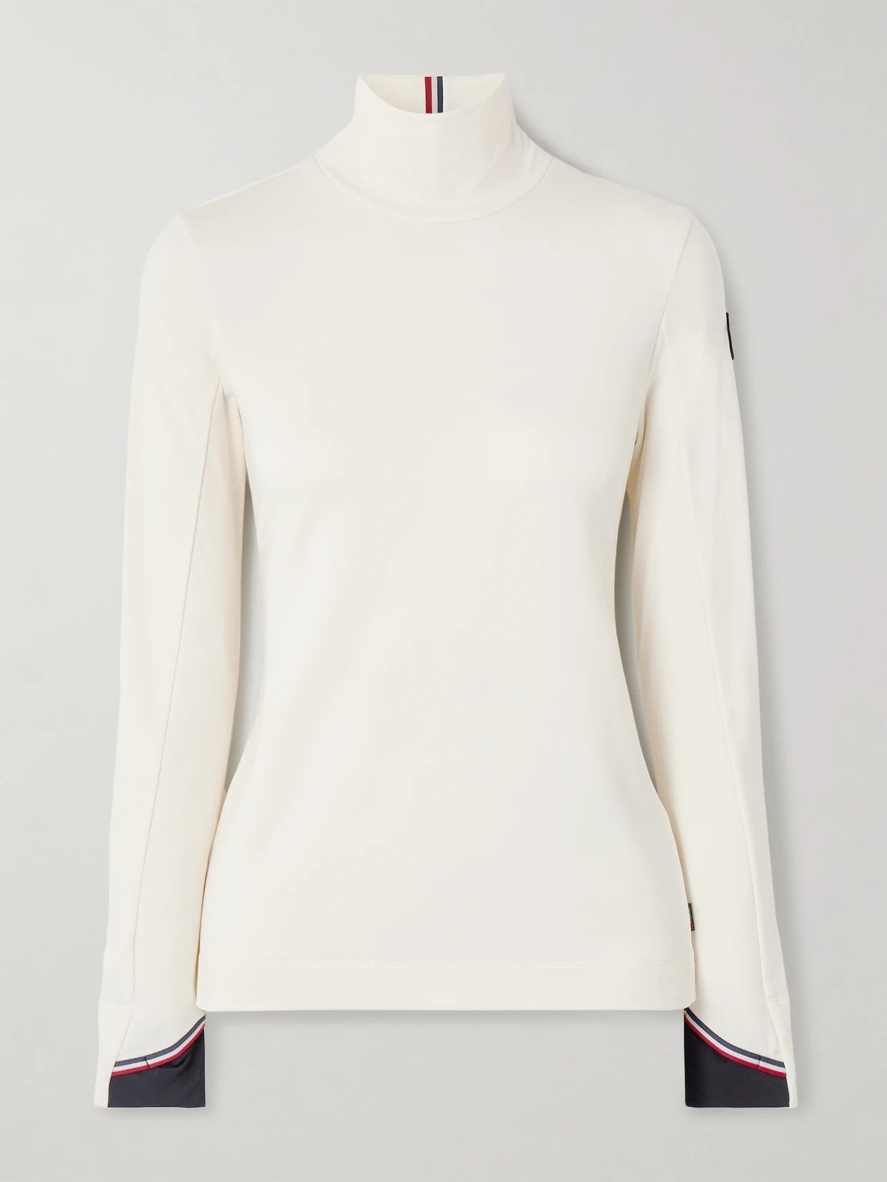 Image of a model wearing Tops. Product name - Polartec Stretch-knit Turtleneck Base Layer in Cream colour by brand - Moncler Grenoble
