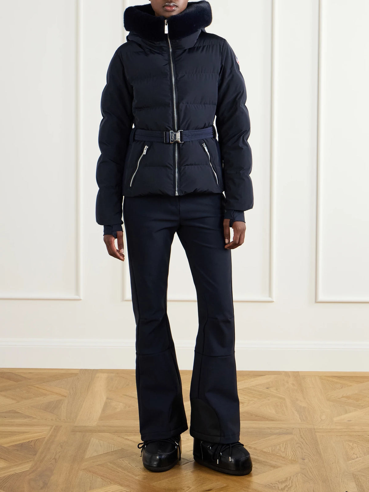 Image of a model wearing Pants. Product name - Pixilae Shell Flared Ski Pants in Navy colour by brand - Fusalp