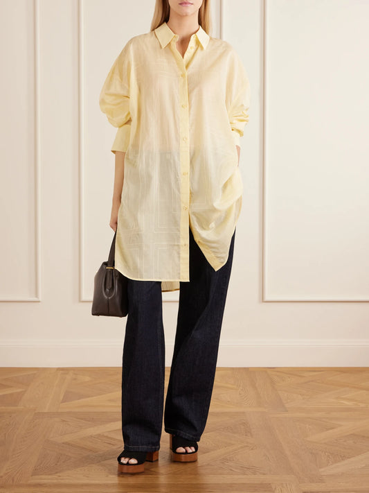 Image of a model wearing Tops. Product name - Lyocell And Cotton-blend Shirt in Pastel yellow colour by brand - TOTEME