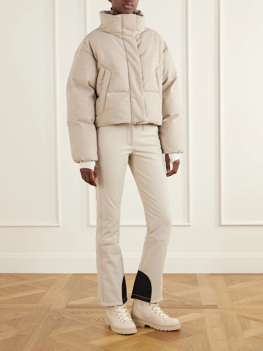 Image of a model wearing Pants. Product name - Sella Belted Stretch-shell Bootcut Ski Pants in Ecru, Chocolate colour by brand - Cordova