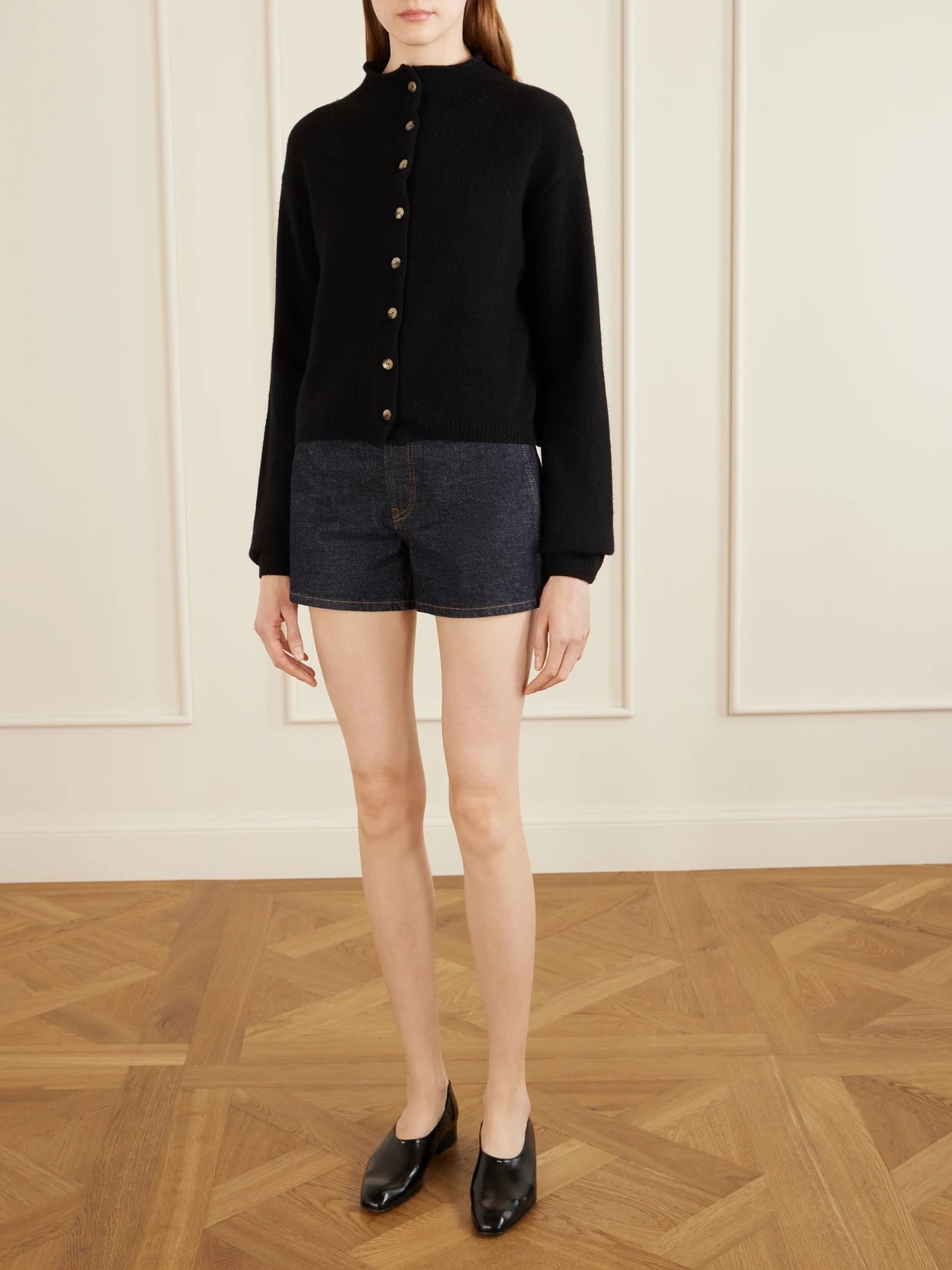 Image of a model wearing Shorts. Product name - Danya Straight-leg Denim Shorts in Dark denim colour by brand - KHAITE