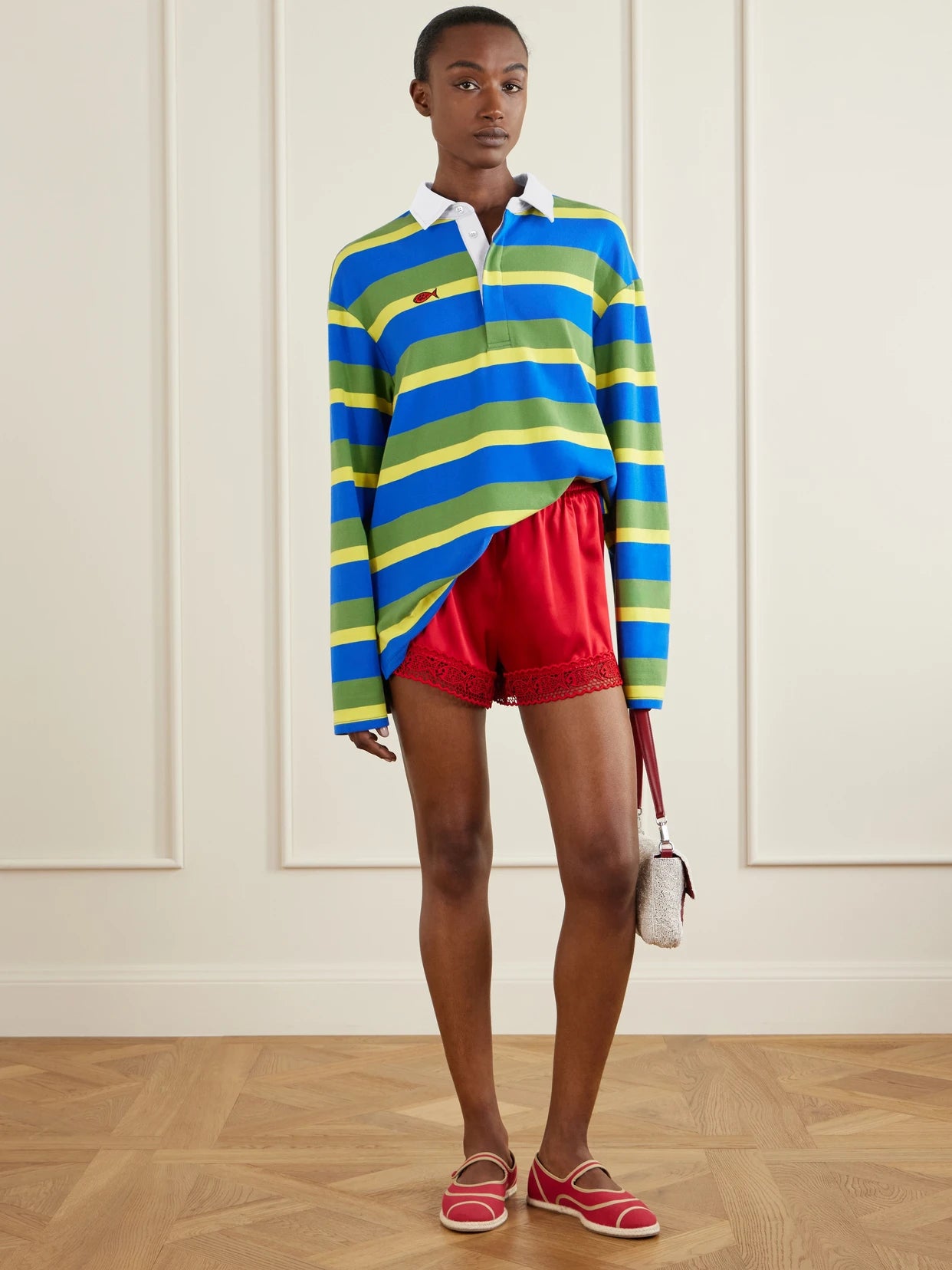 Image of a model wearing Tops. Product name - +da Adolfo Gavin Striped Logo-embroidered Cotton-blend Shirt in Blue colour by brand - STAUD
