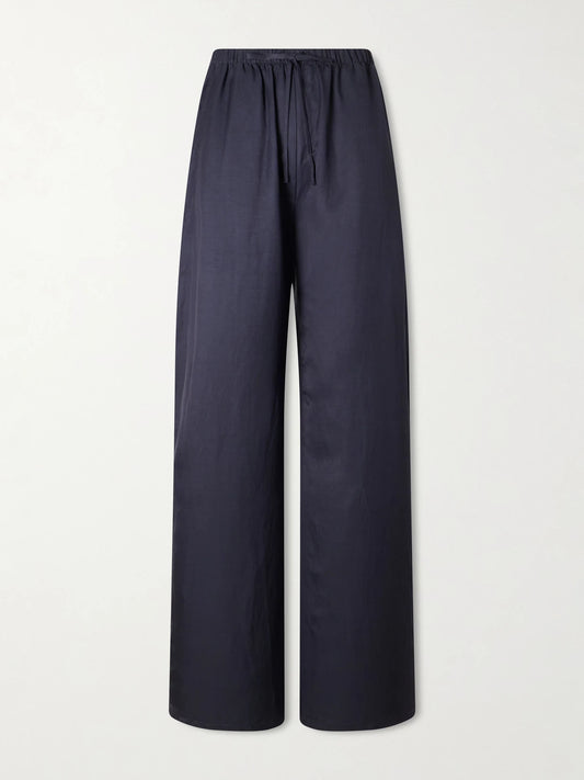 Image of a model wearing Pants. Product name - Daniel Satin Wide-leg Pants in Navy colour by brand - LESET