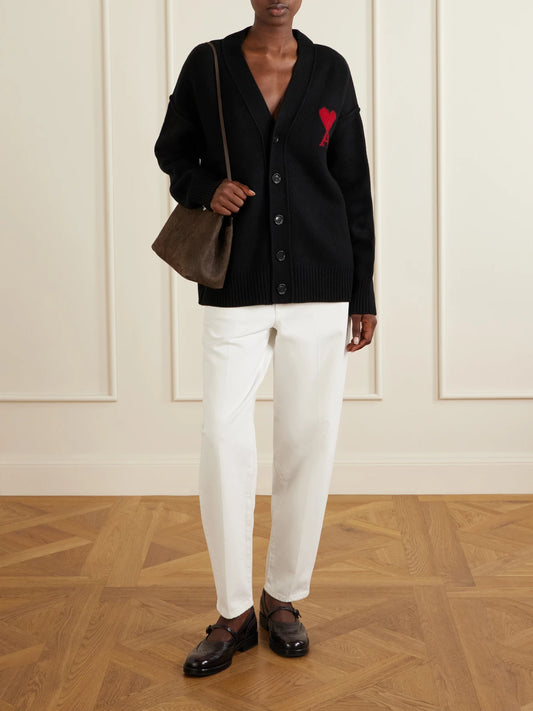Image of a model wearing Outerwear. Product name - Intarsia Merino Wool Cardigan in Black colour by brand - AMI PARIS