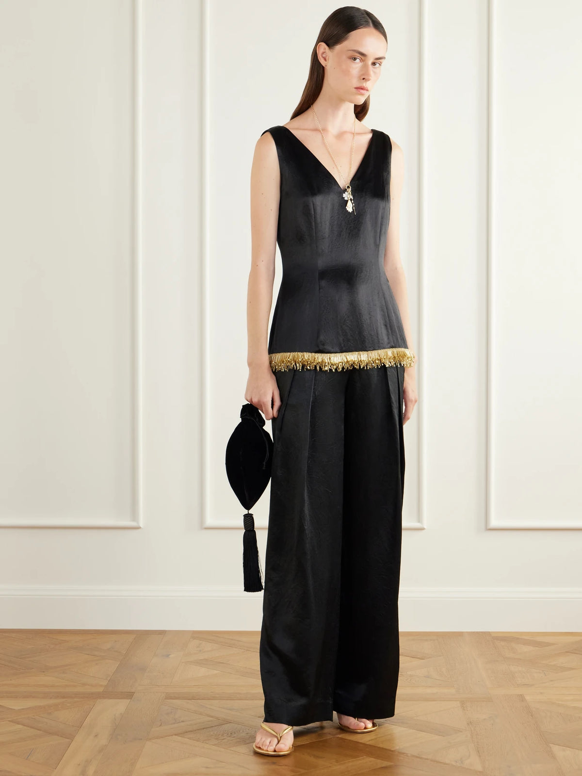 Image of a model wearing Tops. Product name - Kaia Bead-embellished Satin Blouse in Black colour by brand - Abadia