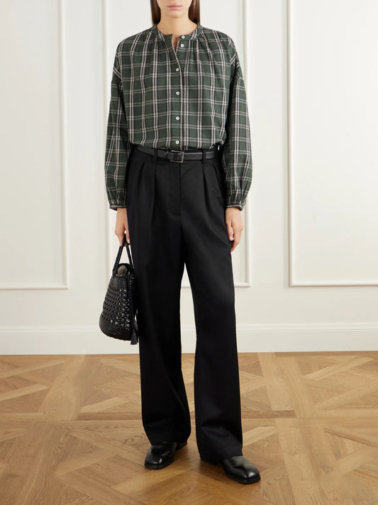 Image of a model wearing Pants. Product name - Painter Pleated Wool-twill Wide-leg Pants in Black colour by brand - SKALL